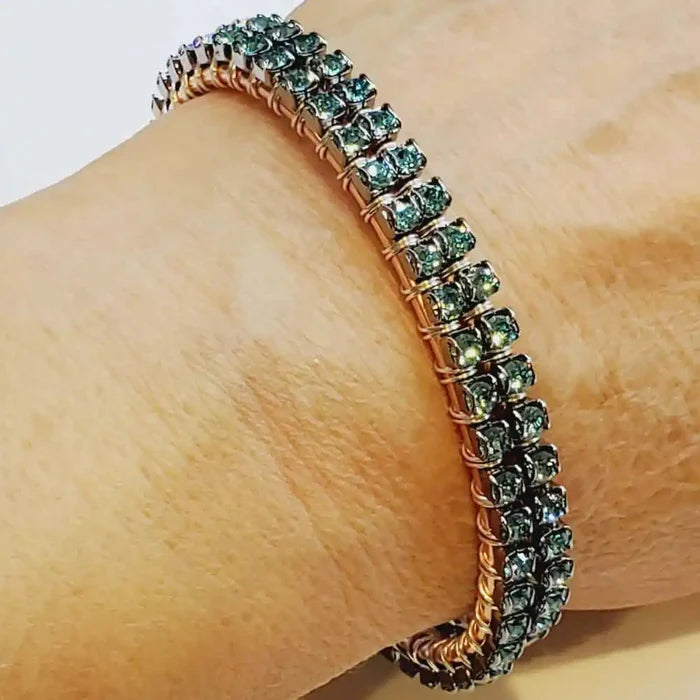 Wire Wrapped Turquoise Crystal Tennis Bangle Bracelet displayed on wrist, featuring aqua blue crystals on a copper bangle.