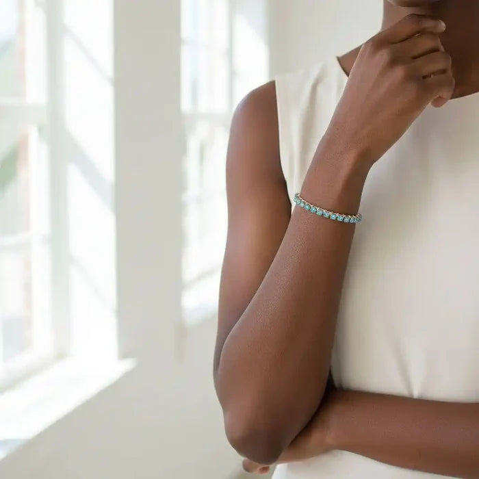 Model wearing Wire Wrapped Turquoise Crystal Tennis Bangle Bracelet showcasing its beautiful aqua blue crystals.