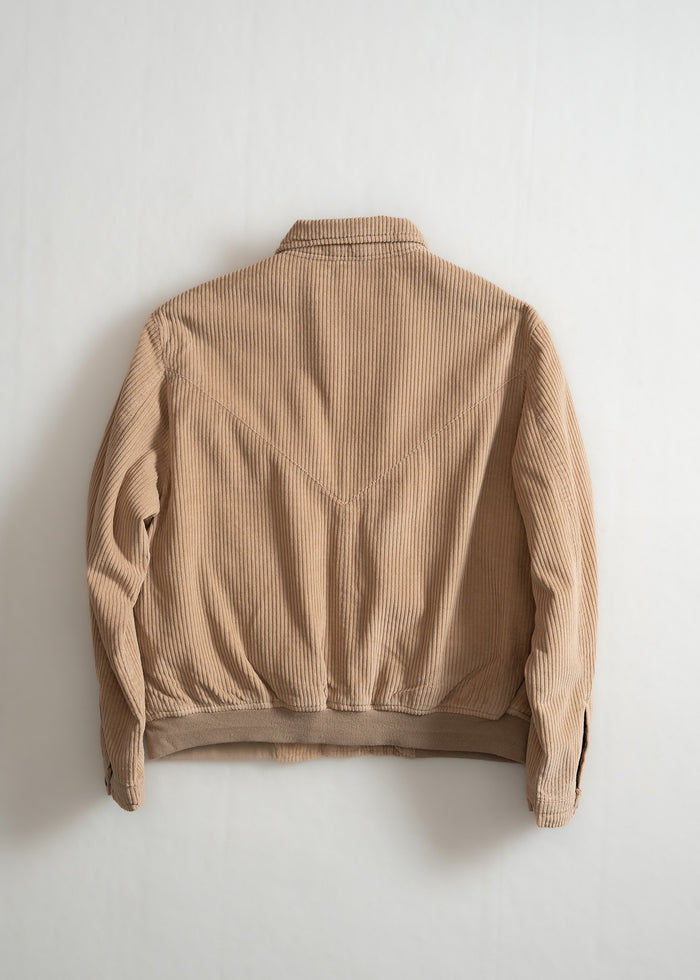 Beige corduroy jacket displayed on a plain background, showcasing its texture and design from the back.