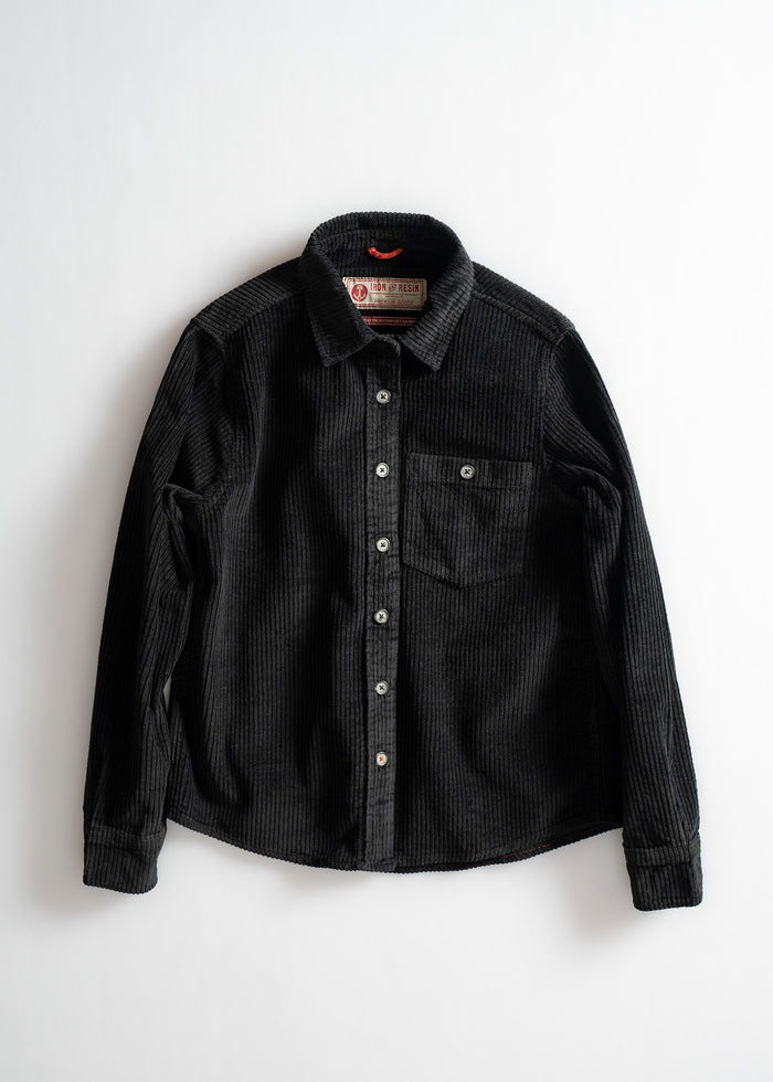 Black corduroy button-up shirt with a chest pocket, displayed on a white background.