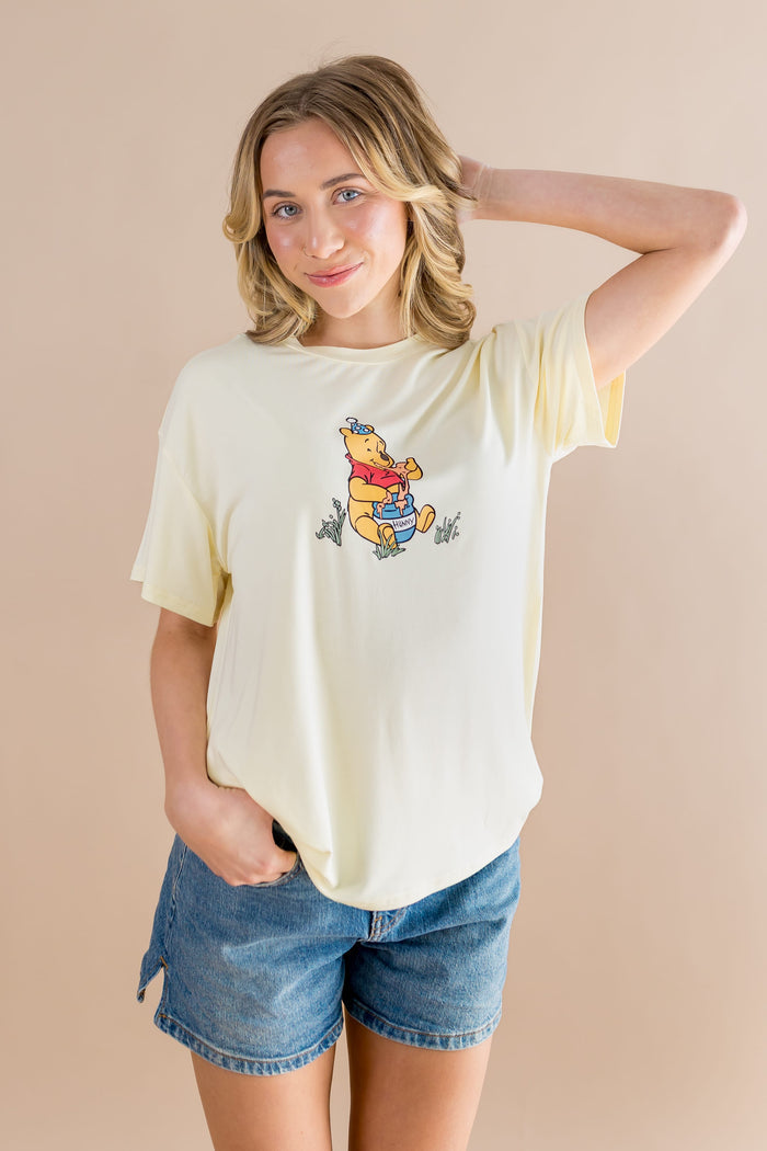 Female model posing wearing the Women's Graphic Tee in Winnie the Pooh on Chamomile