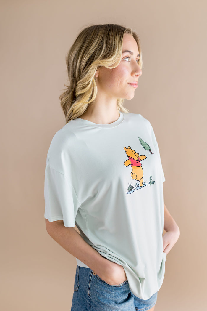 Side view of the Women's Graphic Tee in Winnie the Pooh on Dew
 shown on a female model
