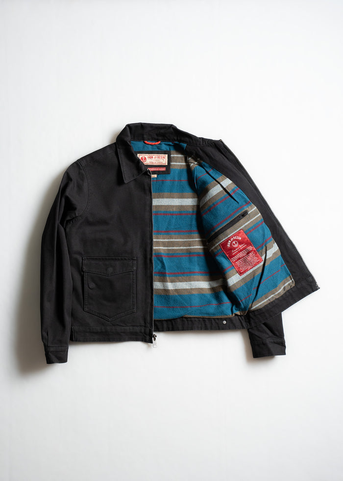 Black jacket with open front reveals striped blue, brown lining. Features a chest pocket and visible red label inside.