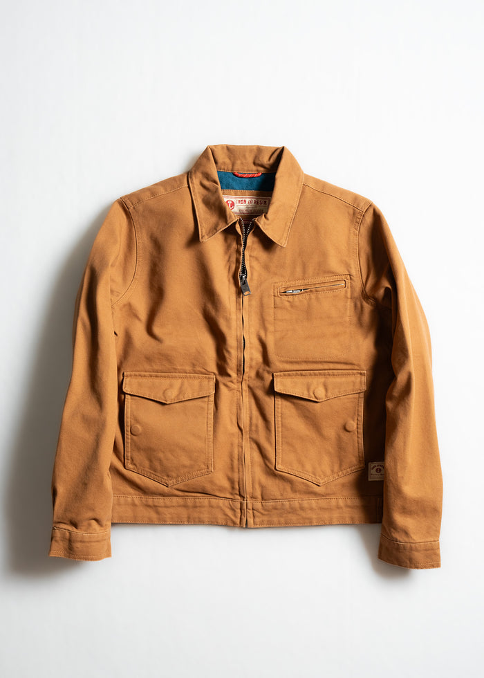 Brown canvas jacket with a zipper, two chest pockets, and a collar, displayed on a white background.