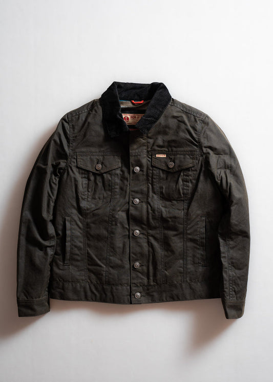 Dark denim jacket with button closure, two chest pockets, and black corduroy collar, displayed on a plain white background.