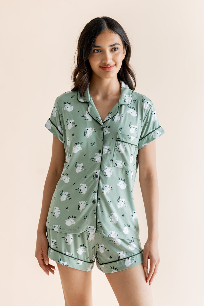 Model wearing Women's Short Sleeve Pajama Set in Koala print on beige background