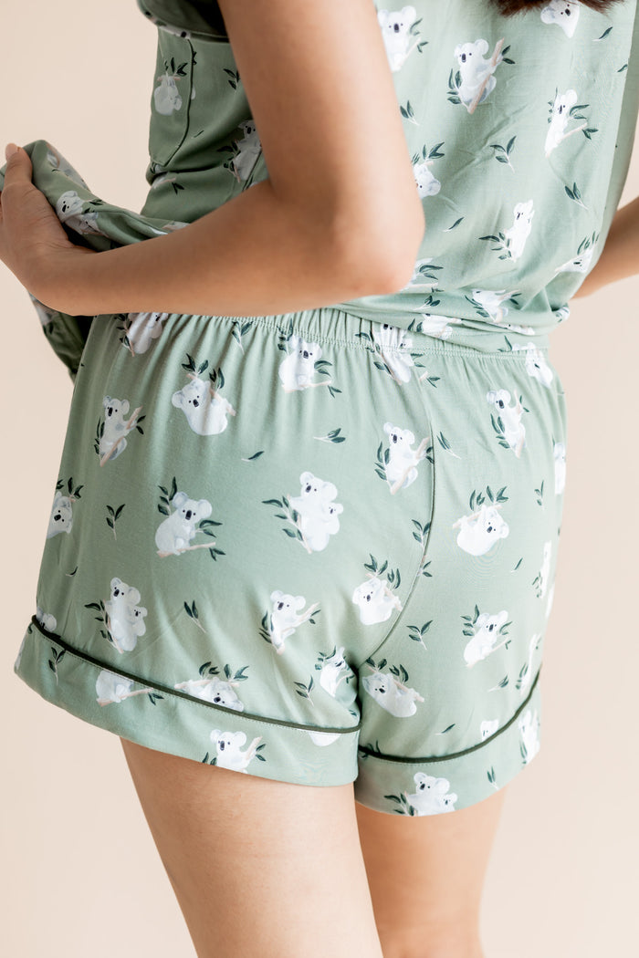 Model showing the back side of  shorts of Women's Short Sleeve Pajama Set in Koala print on beige background