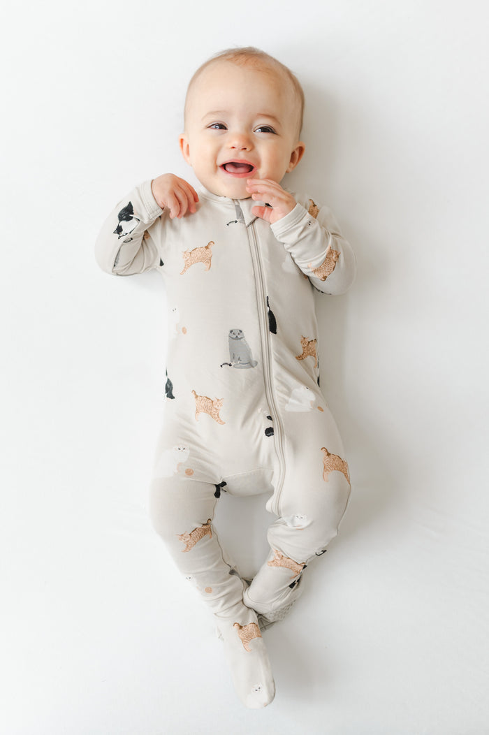 Baby wearing a cat patterned zippered footed pajama