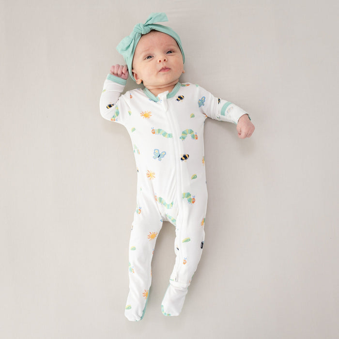 Infant model wearing the Zippered Footie in The Very Hungry Caterpillar™ and Friends with Wasabi Knotted Bow