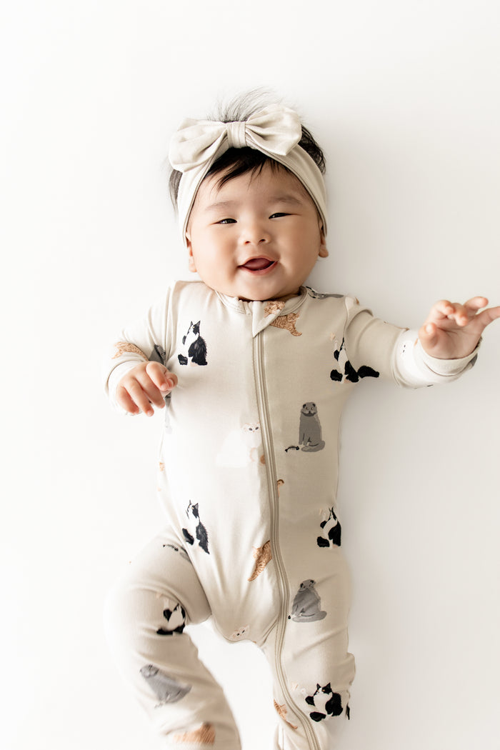Close up of infant wearing the Zippered Romper in Fluffy Cat